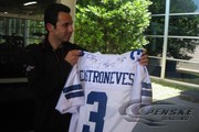 The Dallas Cowboys present Helio Castroneves with a jersey during a promo day in Dallas